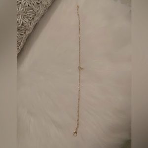 Letter A gold anklet with gem on initial.